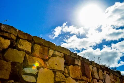 Stone wall with blue sky Stock Photos