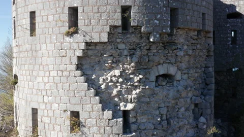 Stone wall of a castle - texture of derelict round tower of a fortress. Ruin of Stock Footage 232555980