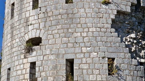 Stone wall of a castle - texture of derelict round tower of a fortress. Ruin of Stock Footage 232712998