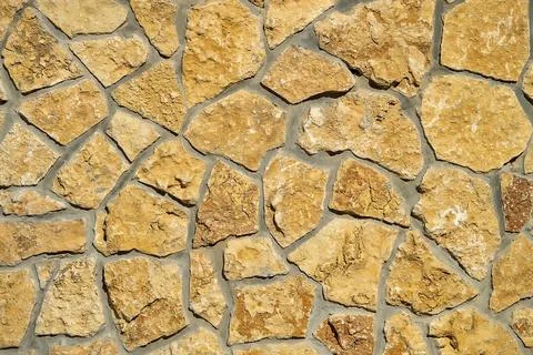 Stone wall of cobblestones background. View from the front. UNUSUAL SURFACE. Foto stock