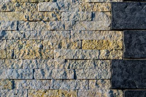 Stone wall, a combination of two different types of stone in one wall Stock Photos
