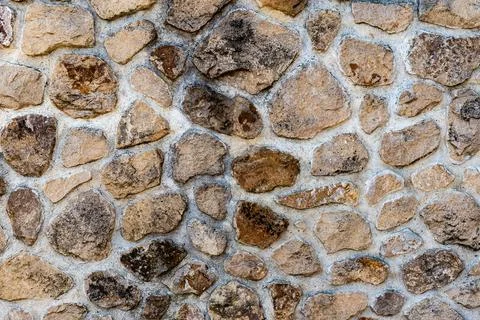 Stone wall composed of irregular blocks of marlstone Stock Photos
