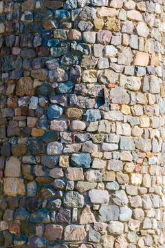 Stone wall constructed from irregular shaped stones and mortar exhibiting n.. Stock Photos