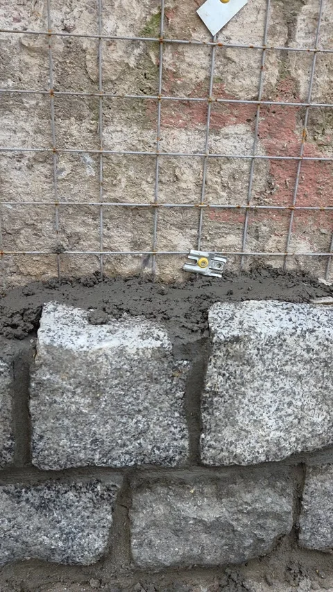 Stone Wall Construction with Wire Mesh Reinforcement Stock Footage 331090753