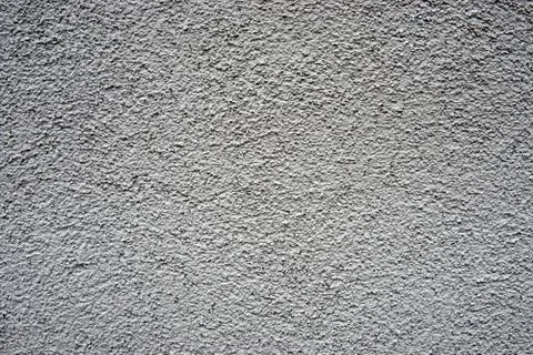 A stone wall covered in plaster Stock Photos