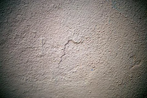 A stone wall covered in plaster Stock Photos