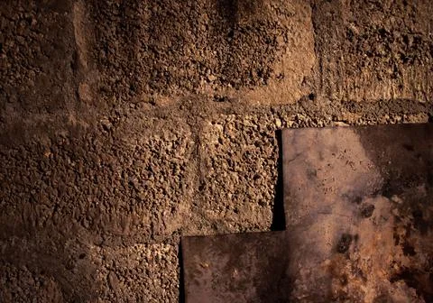 Stone wall dark background with light. Grunge style wall for background Stock Photos