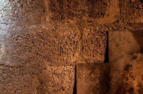 Stone wall dark background with light. Grunge style wall for background Stock Photos