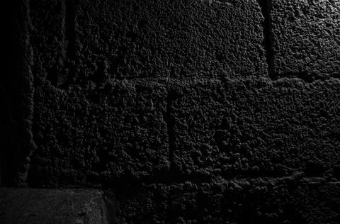 Stone wall dark background with light. Grunge style wall for background Foto stock