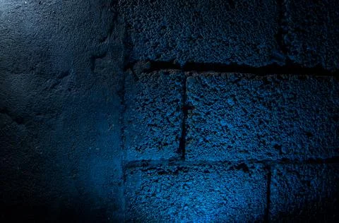 Stone wall dark background with light. Grunge style wall for background Stock Photos