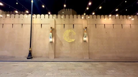 Stone wall decorated with hanging lanterns and Ramadan lights Video stock 330436272