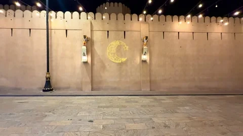 Stone wall decorated with hanging lanterns and Ramadan lights Stock Footage 330436273
