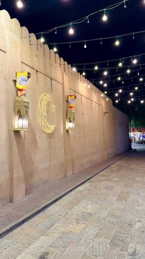 Stone wall decorated with hanging lanterns and Ramadan lights Stock Footage 330436274