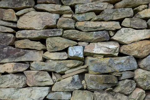 Stone wall fence rustic texture background close-up. 스톡 사진