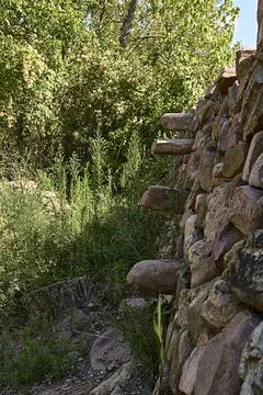 Stone wall for the fields with stone steps to climb. Stock Photos