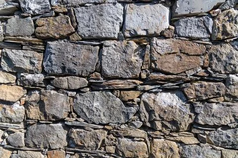 Stone wall with fitted rectangular blocks in outdoor facade Stock Photos