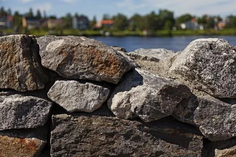 Stone wall in front of river landscape Stock Photos