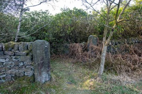 A stone wall with a gate in the middle Stock Photos