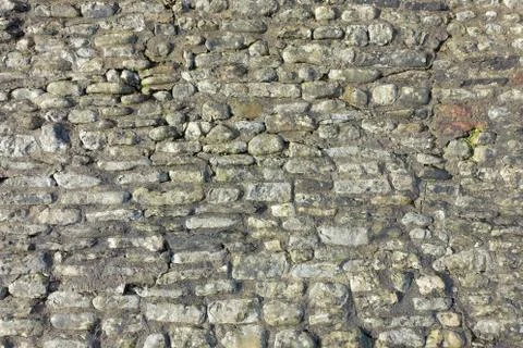 Stone wall illuminated by sun as background Stock Photos