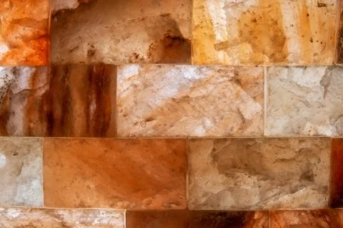 Stone wall with lighting from the inside. Texture. White, red and orange domi Stock-Fotos