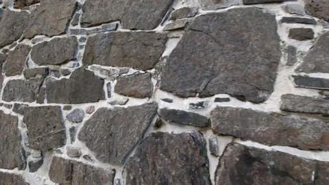 Stone wall made of large rocks and boulders - abstract background and texture of Stock Footage 232280564