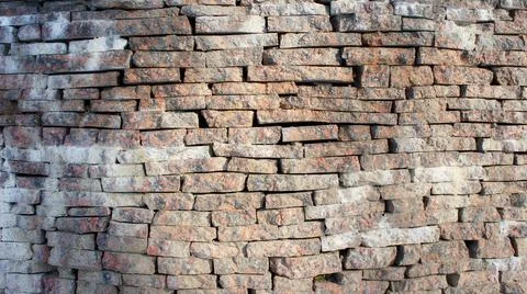 Stone wall made of marble bricks. marble brick wall texture &amp; pattern Stock Photos