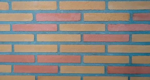 Stone wall made of rectangular bricks closeup Stock Photos