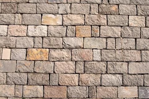 Stone wall made of regular oblong pieces 库存照片
