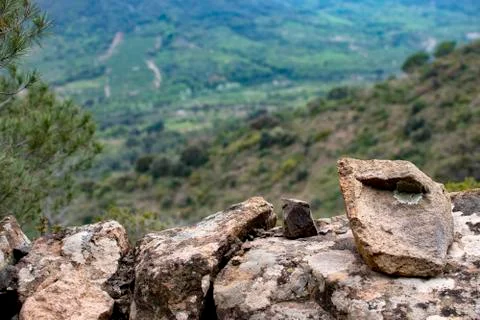 Stone wall made of rocks in the mountains. Stock Photos