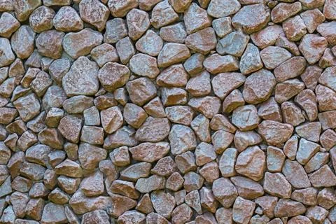 Stone wall many stone mini tiles cobblestones hard base wall background Stock Photos