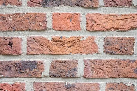 Stone wall with much brown bricks of the modern building. Stock Photos