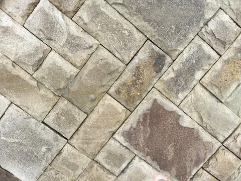 A stone wall with a pattern of squares and triangles 写真素材