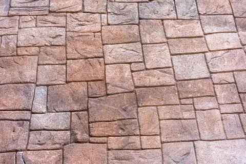 The stone wall is patterned in light brown tones, each cube is different, s.. Stock Photos