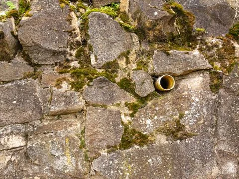 Stone wall with plastic wall ventilation pipe Stock Photos
