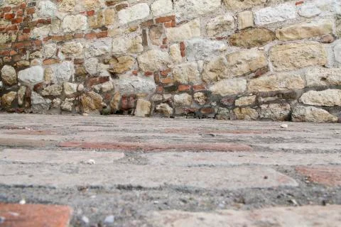 Stone wall with red bricks in like a flour or ceiling Foto stock