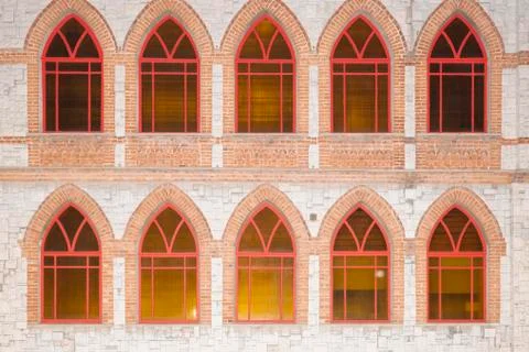 Stone wall with red Windows as background 스톡 사진
