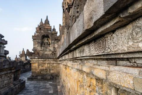 Stone wall showing bas-reliefs and stupas at plaosan temple Photos