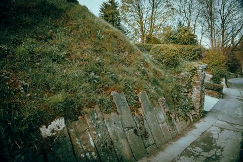 Stone wall by the side of a road Photos