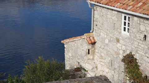 Stone wall with a single window - old house on the coast of Mediterranean sea Stock Footage 231279354