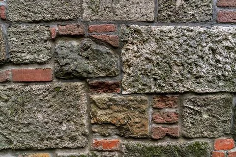Stone wall is solid and smooth from cobblestones old town Stock Photos