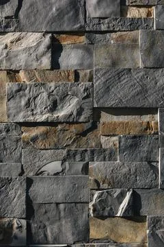 Stone wall in sunlight. Sharp shadows emphasize the textere. Different size cut 库存照片