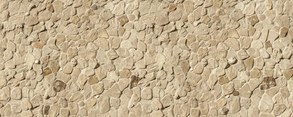 Stone wall surface creating a rustic texture background Stock Photos