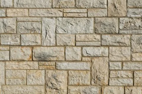 Stone wall with a symmetrical brick pattern Stock Photos