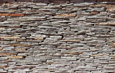 Stone wall texture and background made from pieces of old flat golden sandsto Stock Photos