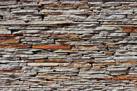 Stone wall texture and background made from pieces of old flat golden sandsto Stock Photos