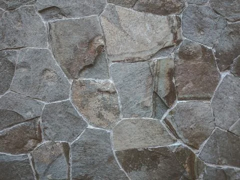 Stone wall texture and background. The walls are decorated with natural stone. Stock Photos