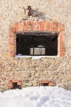 Stone wall texture and windows with red frames, natural background pattern Stock Photos