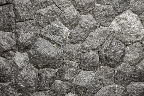 Stone wall texture background - grey stone siding with different sized stones Stock Photos