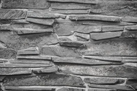 Stone wall texture background - grey stone siding with different sized stones Stock Photos