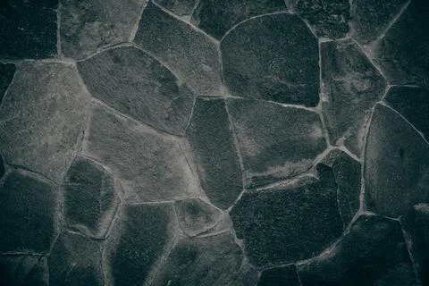 Stone wall texture background - grey stone siding with different sized stones Stock Photos